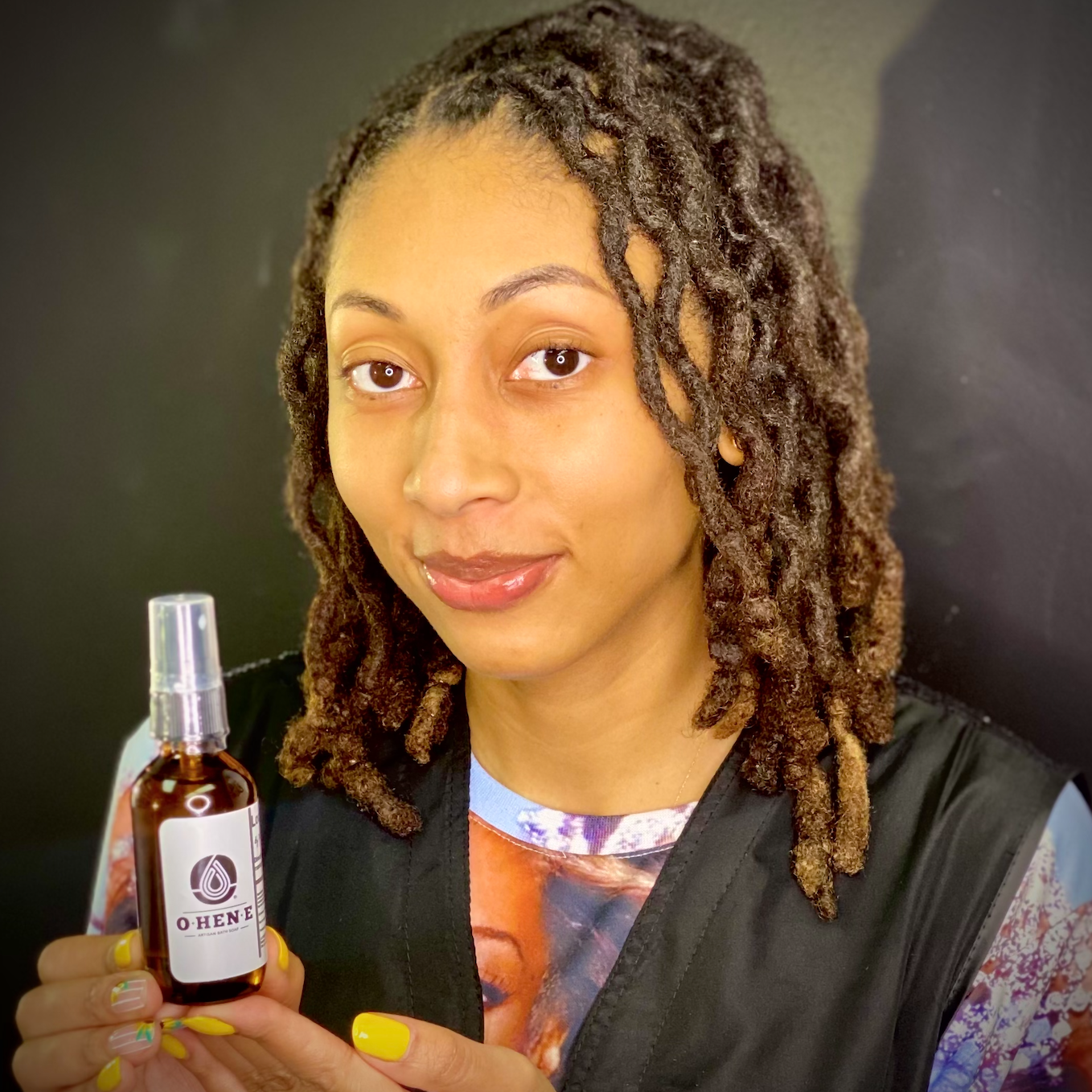 Maya Marchelle poses with OHENE Loc Libation Hair moisturizing oil